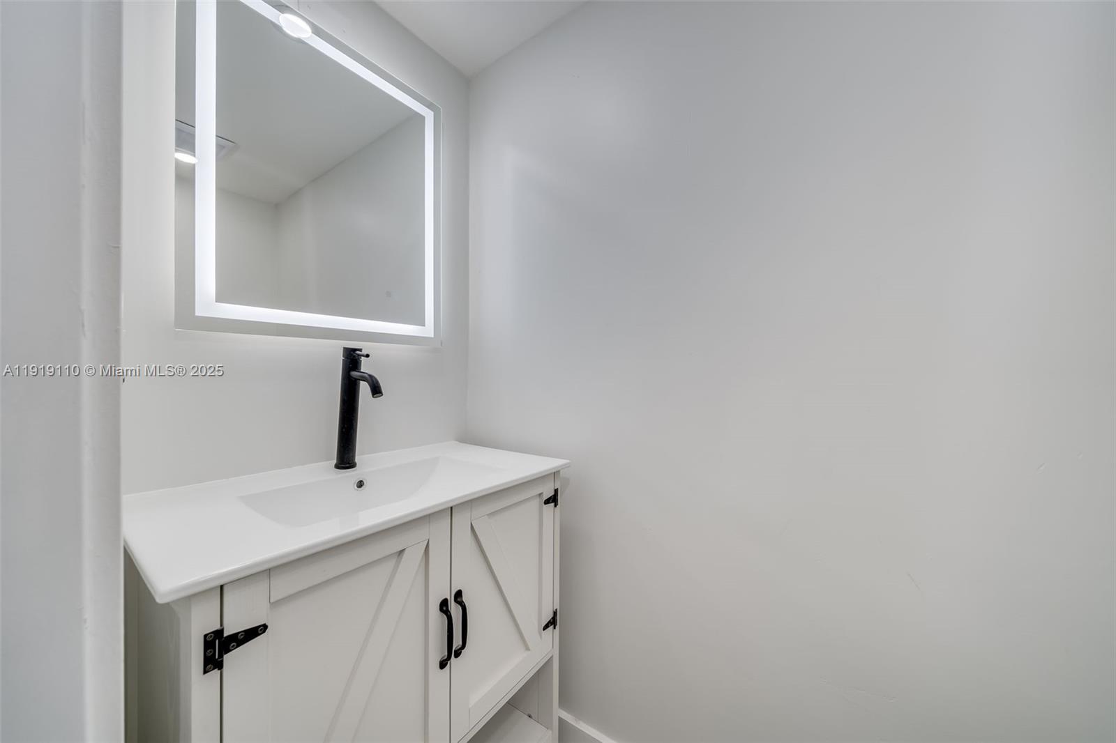 4155 Southwest 66th Terrace, Unit 104 Davie, FL 33314 - Photo 7 of 25 a sink and a mirror