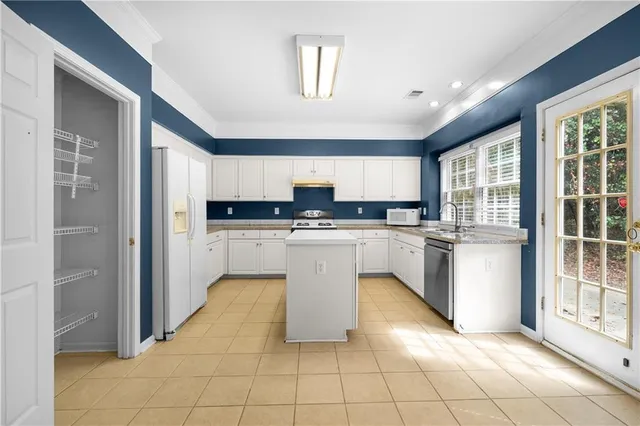 a kitchen with cabinets and window