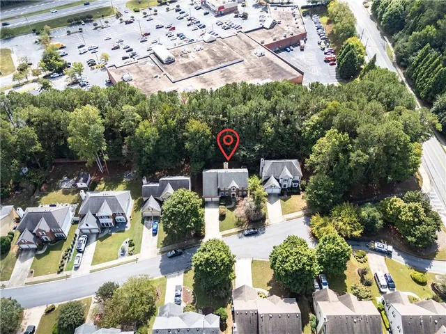 an aerial view of a house with a yard and garden