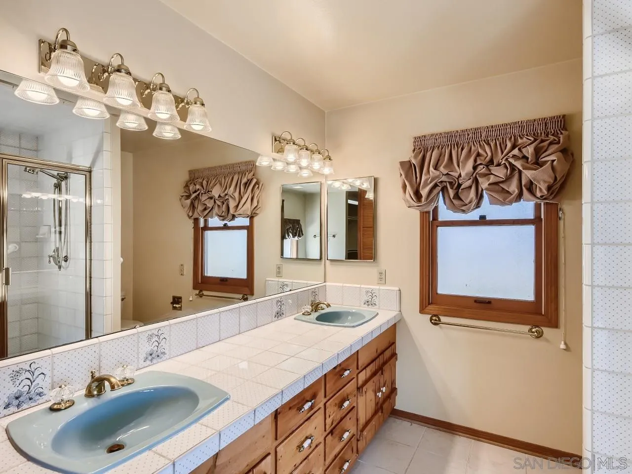 16363 Espola Road Poway, CA 92064 - Photo 17 of 43 a bathroom with a sink a mirror and a shower