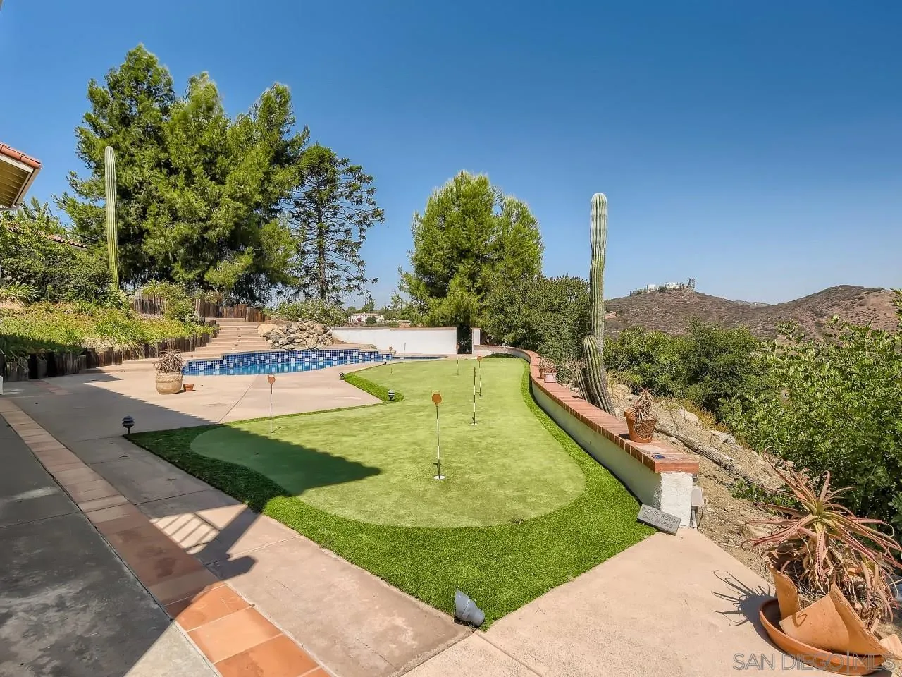 16363 Espola Road Poway, CA 92064 - Photo 33 of 43 a view of a swimming pool with a yard