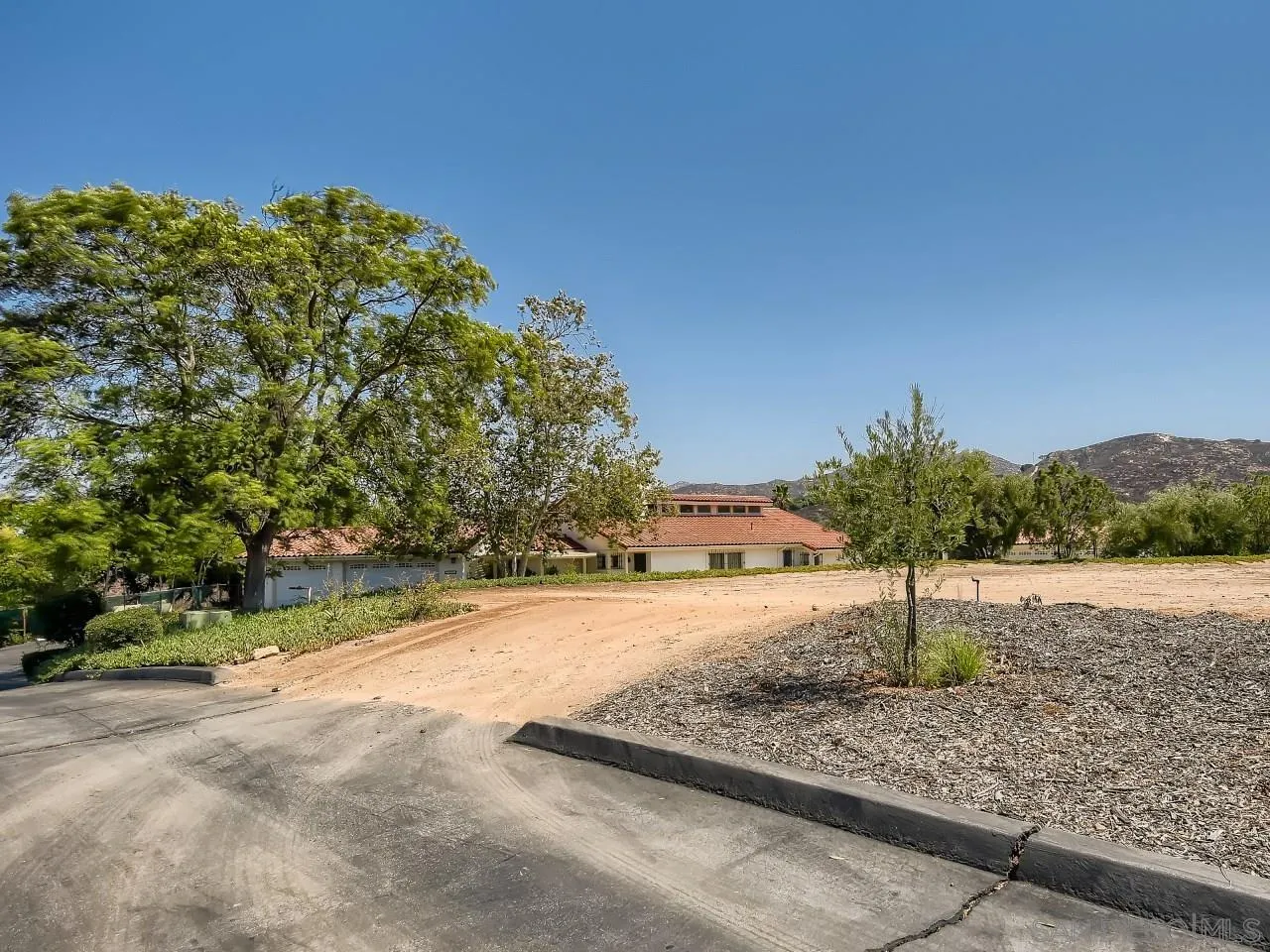 16363 Espola Road Poway, CA 92064 - Photo 4 of 43 a view of a street with a yard and large trees