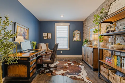 a workspace with furniture bookshelf and a window