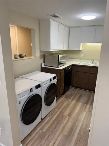 a kitchen with a washer and dryer in it