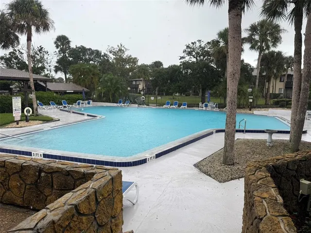 a view of a swimming pool with a patio