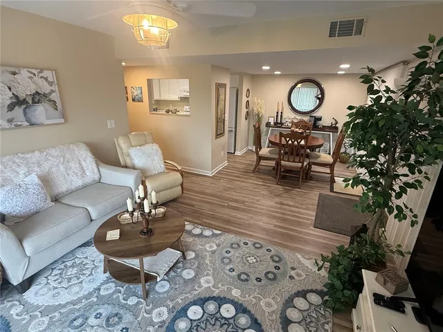 a living room with furniture and a mirror