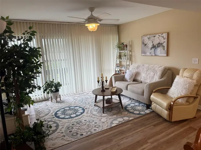 a living room with furniture and a potted plant