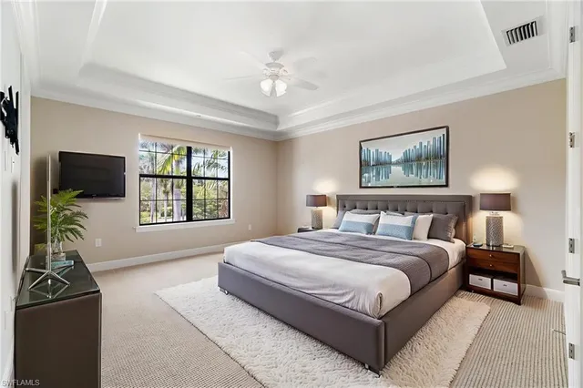 a spacious bedroom with a bed and a window