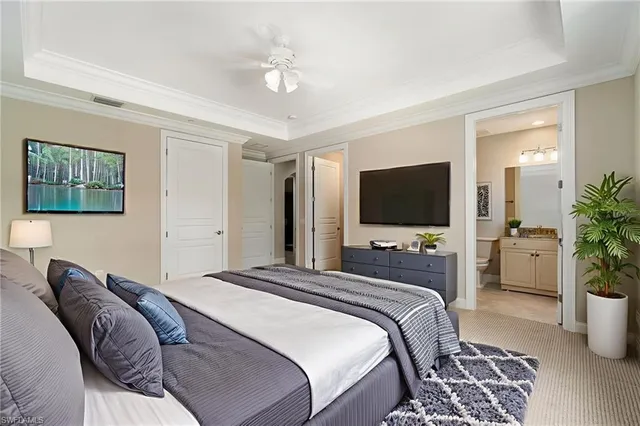 a spacious bedroom with a large bed and a flat screen tv