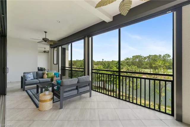 a living room with furniture and a floor to ceiling window