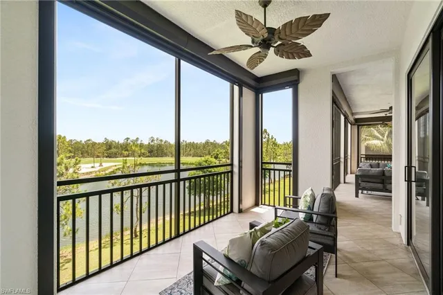 a living room with furniture and a floor to ceiling window
