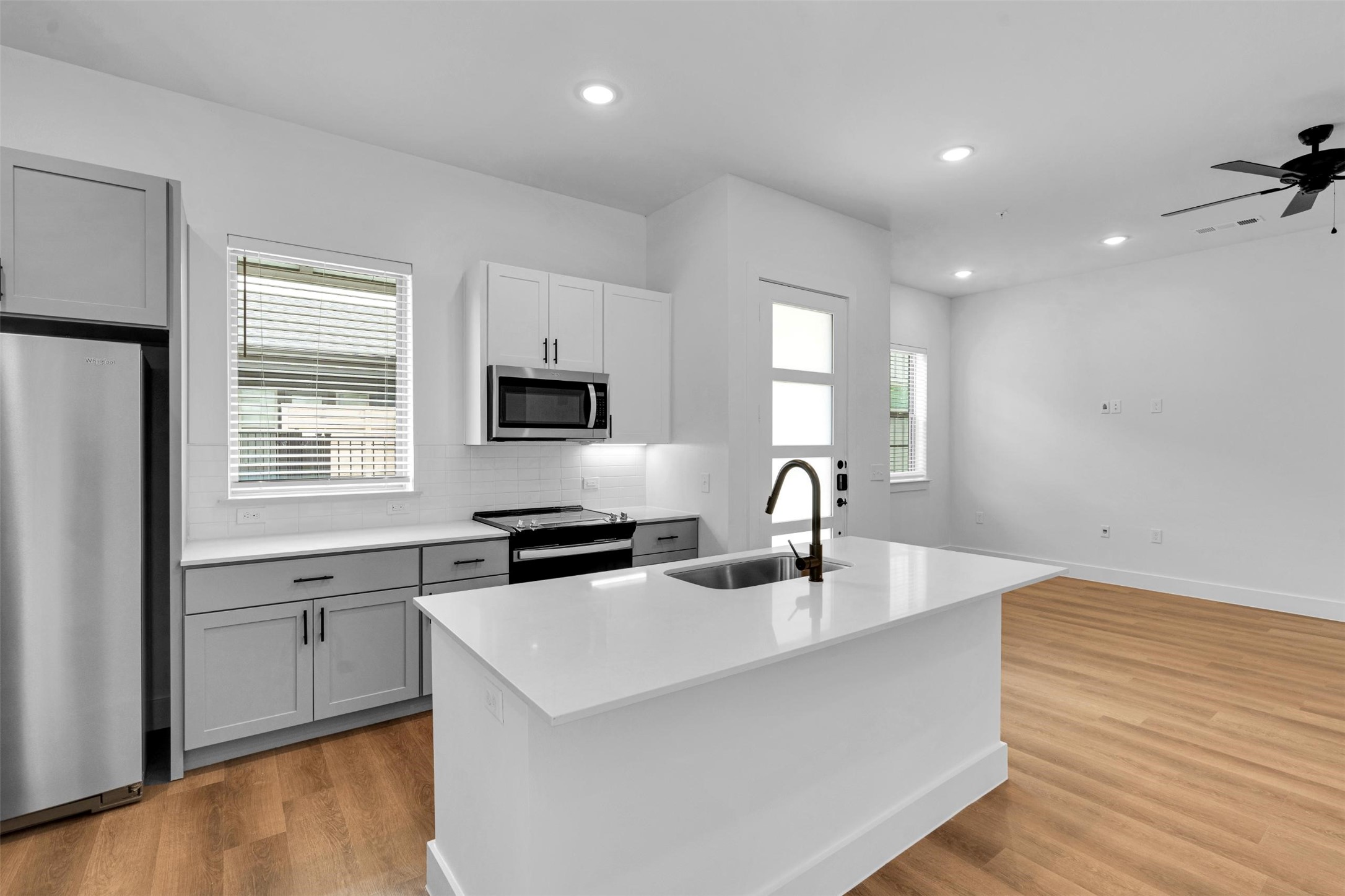 1648-104 Spaniel Avenue Rowlett, TX 75089 - Photo 6 of 31 a kitchen with stainless steel appliances a sink a stove a refrigerator cabinets and a window