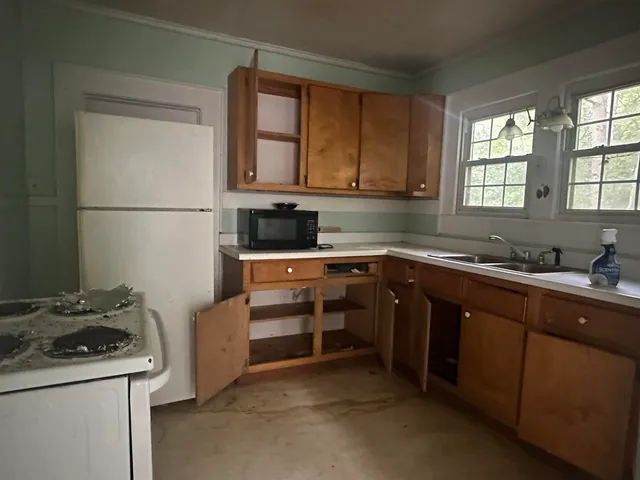 a kitchen with a sink stove and cabinets