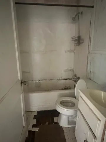 a toilet sitting next to a bathroom sink