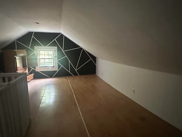 a living room with a car parked and a potted plant