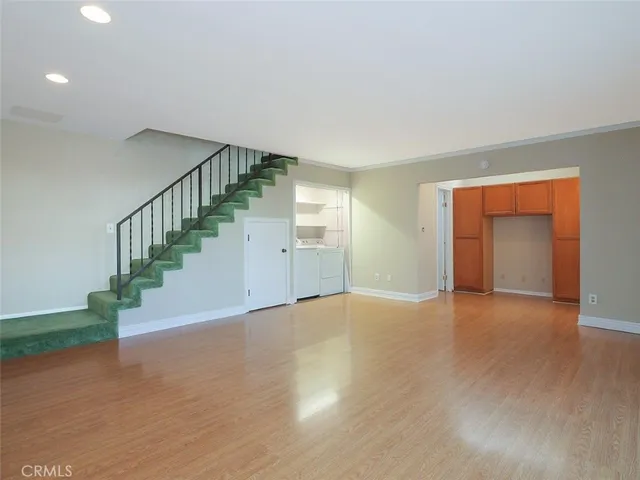 a view of an empty room with stairs and a fireplace
