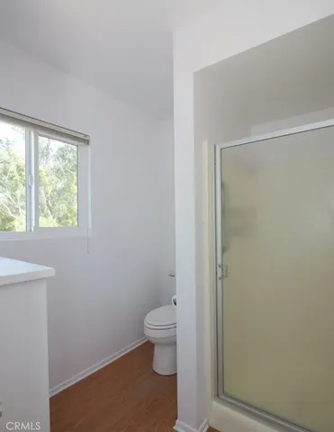 a bathroom with a granite countertop toilet and a shower