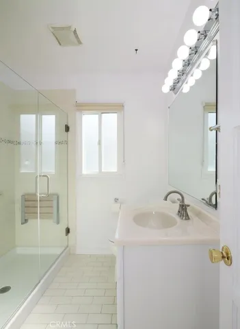 a bathroom with a tub a sink and a mirror