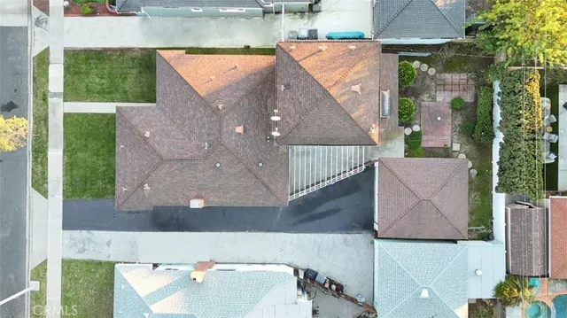 an aerial view of houses with a yard