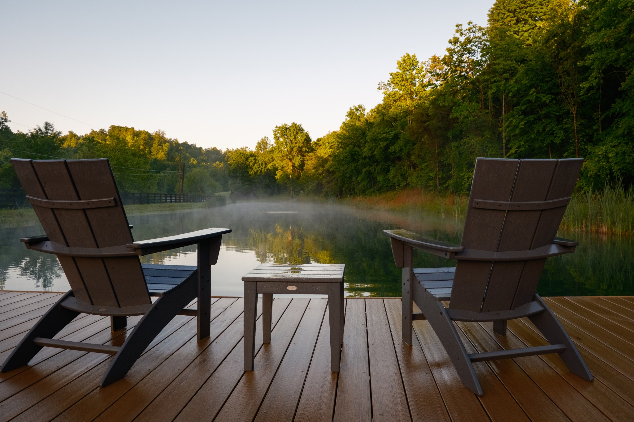 7556 Caney Fork Road Fairview, TN 37062 - Photo 27 of 47 a view of a roof deck with table and chairs a barbeque with wooden floor and fence