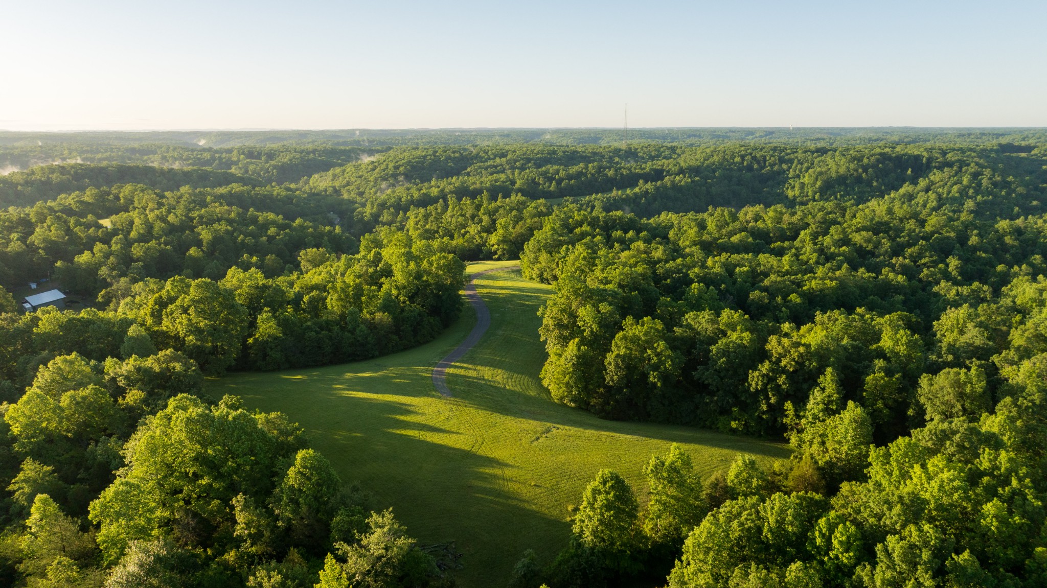 7556 Caney Fork Road Fairview, TN 37062 - Photo 3 of 47 a view of a lake with a mountain in the background