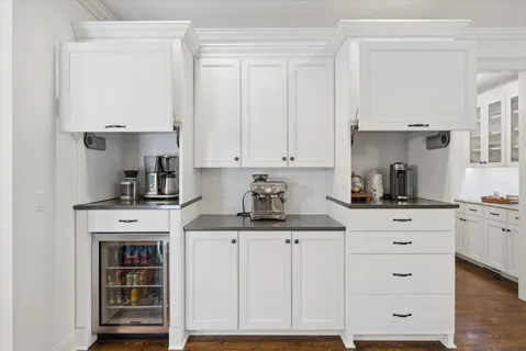 a kitchen with granite countertop white cabinets and white appliances