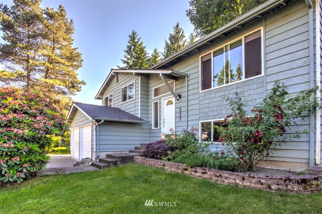 17510 24th Avenue Southeast Bothell, WA 98012 - Photo 14 of 20 a front view of a house with a garden and plants