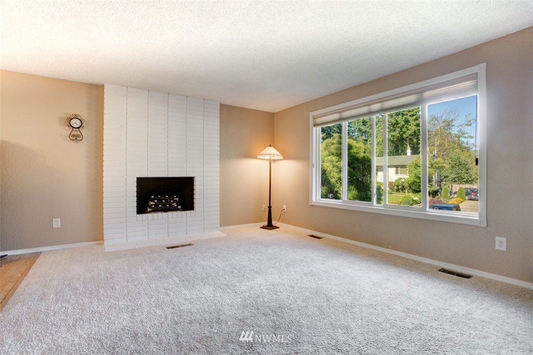 17510 24th Avenue Southeast Bothell, WA 98012 - Photo 15 of 20 a view of an empty room with a fireplace and a window