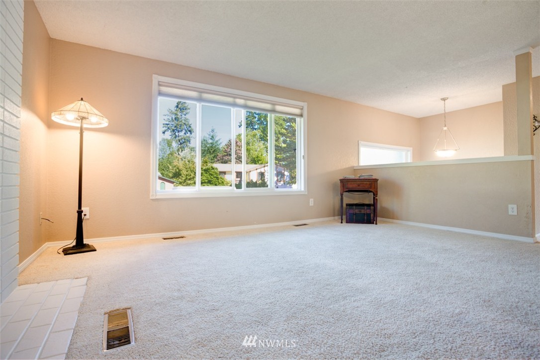 17510 24th Avenue Southeast Bothell, WA 98012 - Photo 16 of 20 a view of an empty room with a fireplace and a window