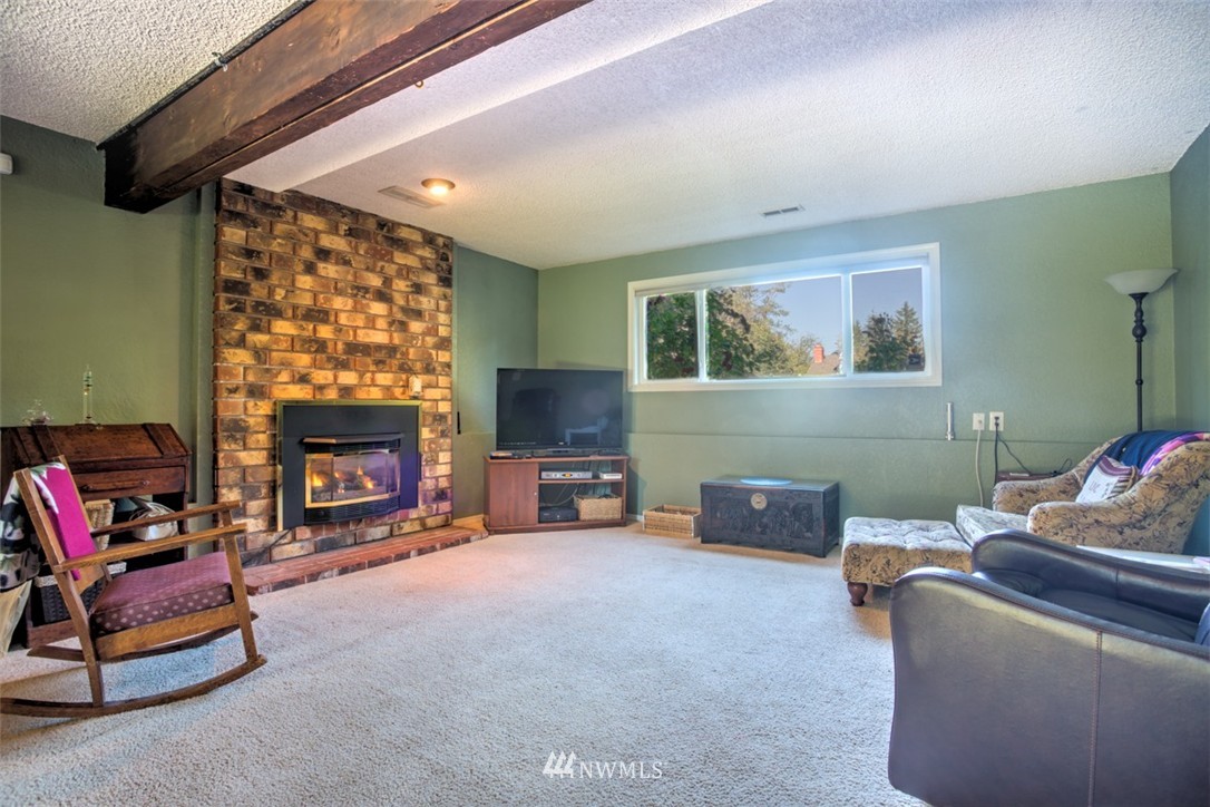17510 24th Avenue Southeast Bothell, WA 98012 - Photo 18 of 20 a living room with furniture and a fireplace
