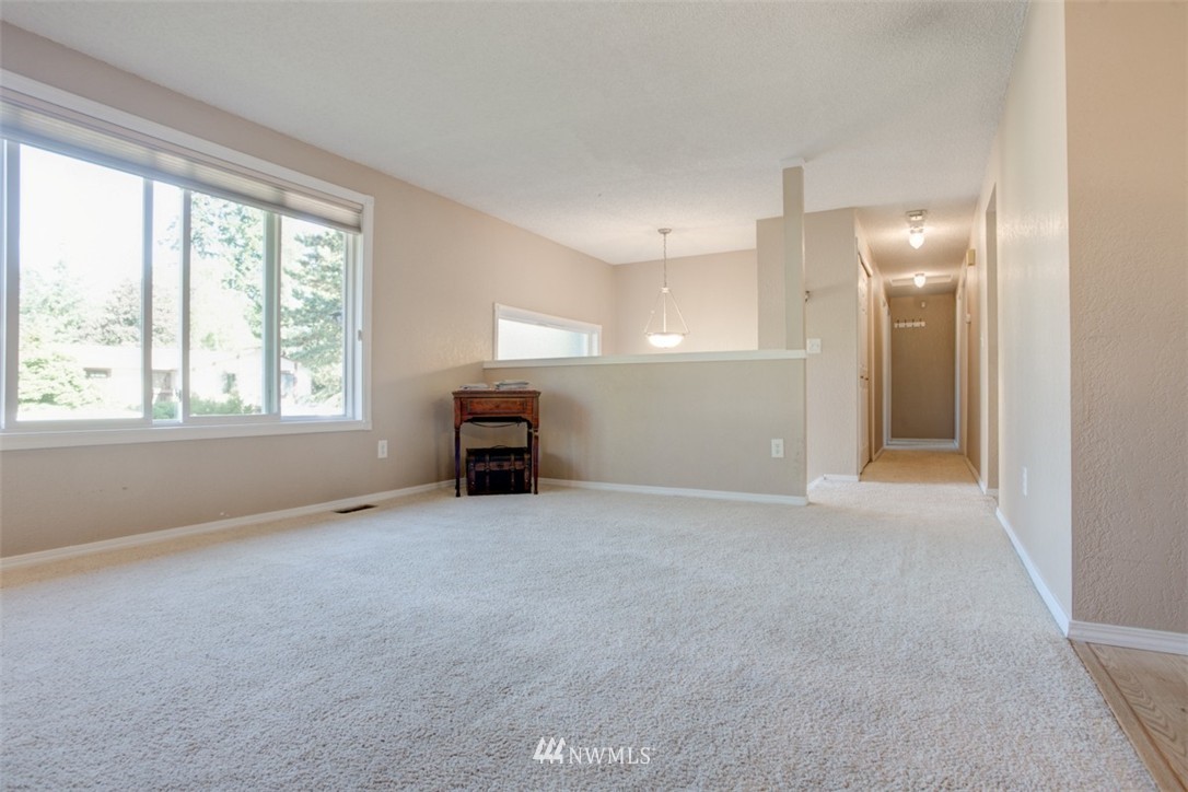 17510 24th Avenue Southeast Bothell, WA 98012 - Photo 4 of 20 an empty room with furniture and a window
