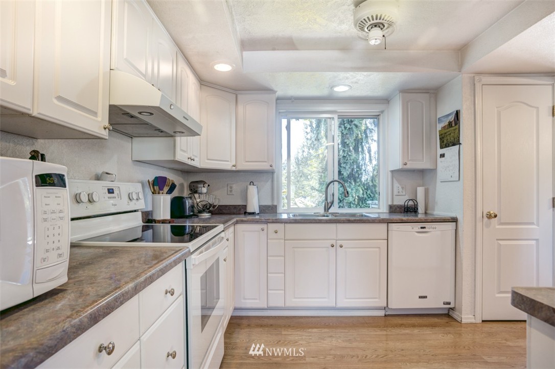 17510 24th Avenue Southeast Bothell, WA 98012 - Photo 6 of 20 a kitchen with white cabinets and window