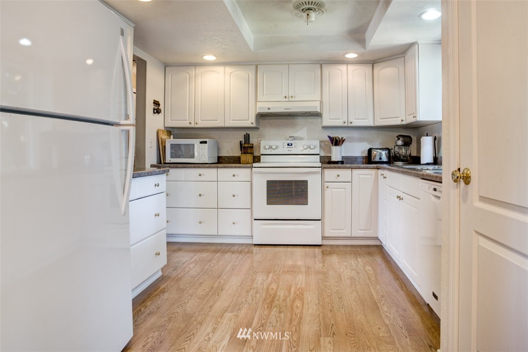 17510 24th Avenue Southeast Bothell, WA 98012 - Photo 8 of 20 a kitchen with white cabinets and white appliances