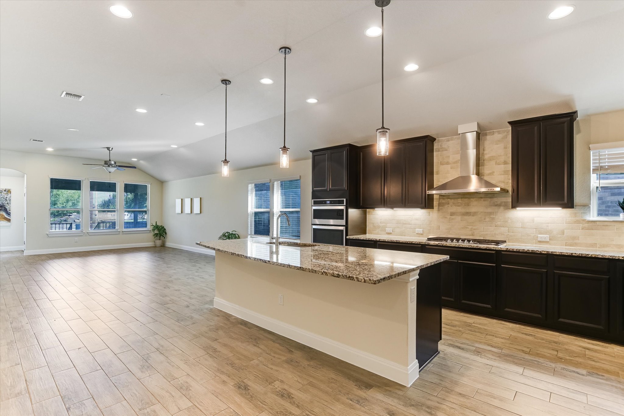 18211 Winnow Way Pflugerville, TX 78660 - Photo 1 of 1 Kitchen featuring tasteful backsplash, recessed lighting, lofted ceiling, pendant lighting, and a ceiling fan