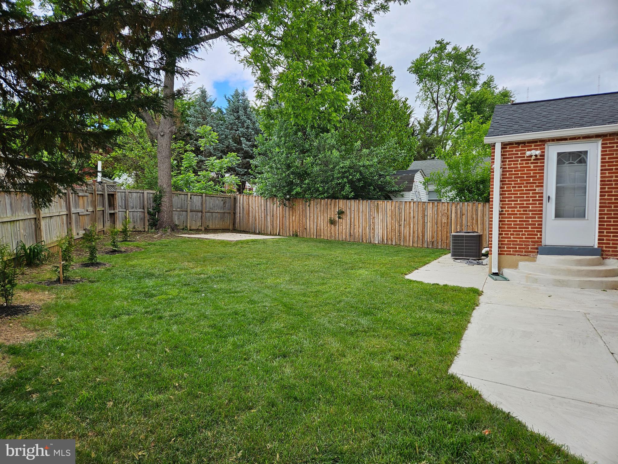 11102 Bucknell Drive Silver Spring, MD 20902 - Photo 14 of 14 a view of a backyard with a small cabin and wooden fence