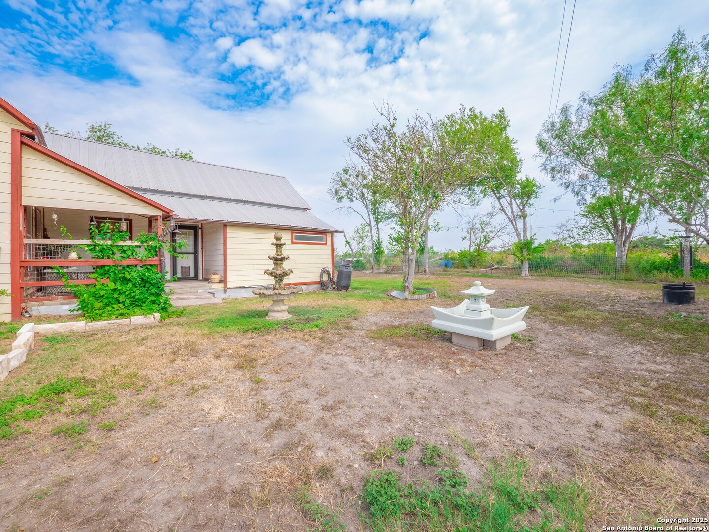 a view of a backyard with large trees