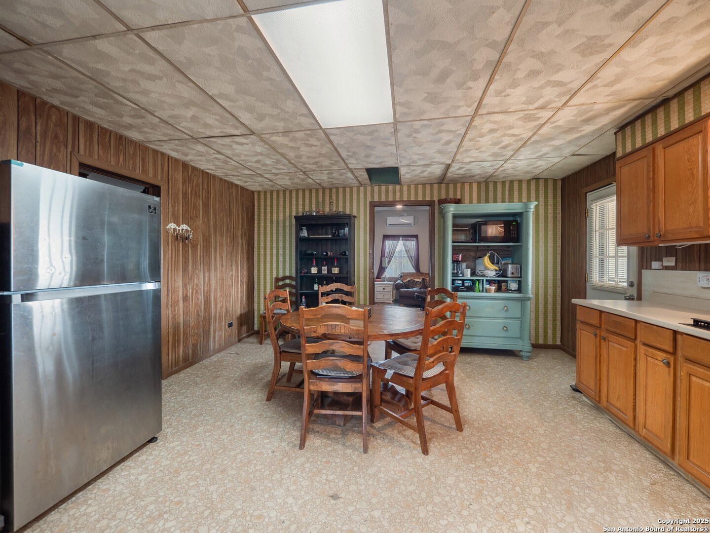 6147 Pfeil Road Schertz, TX 78154 - Photo 11 of 47 a dining room with furniture a kitchen and stainless steel appliances