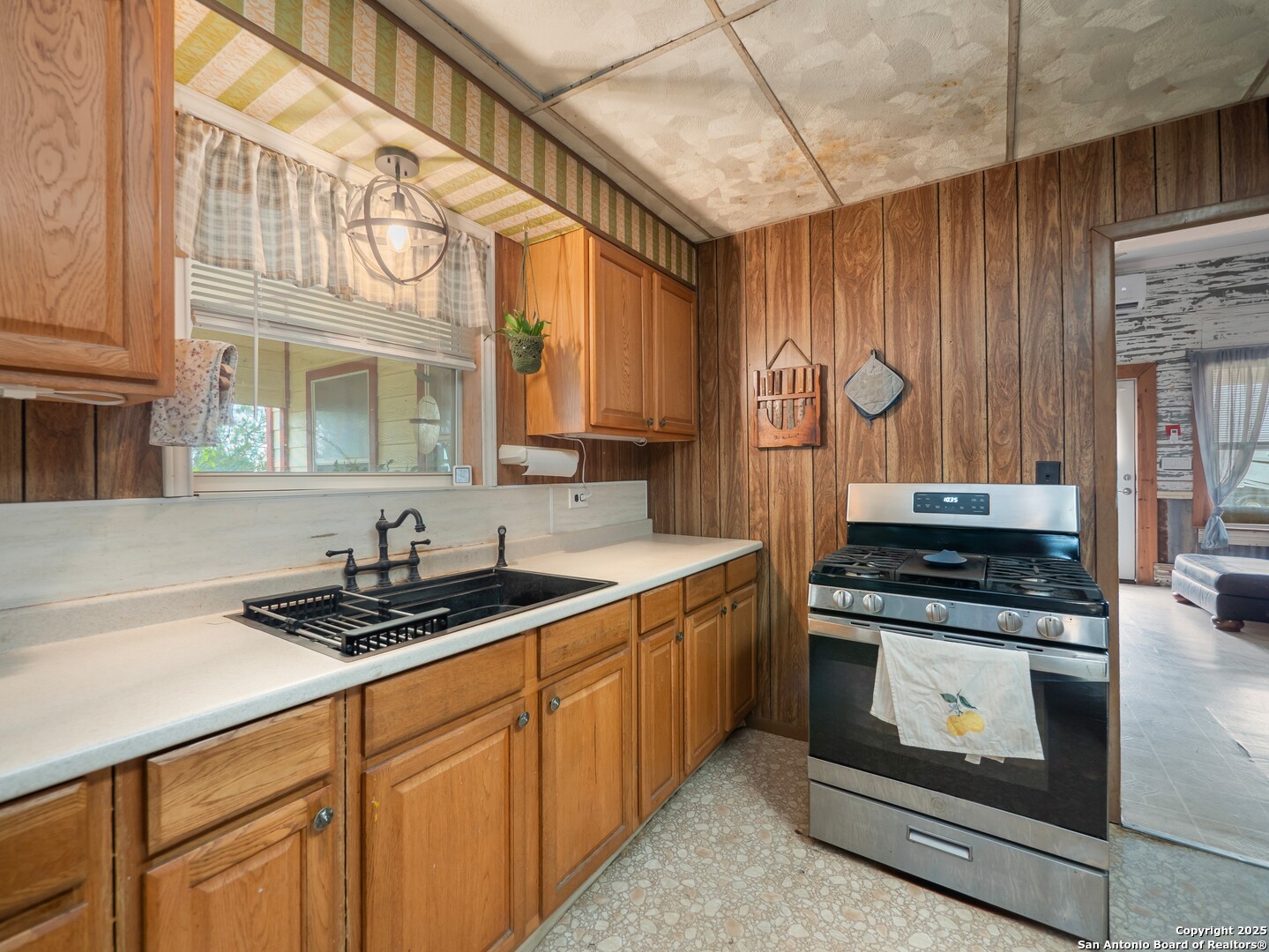 6147 Pfeil Road Schertz, TX 78154 - Photo 14 of 47 a kitchen with stainless steel appliances granite countertop a stove and a sink