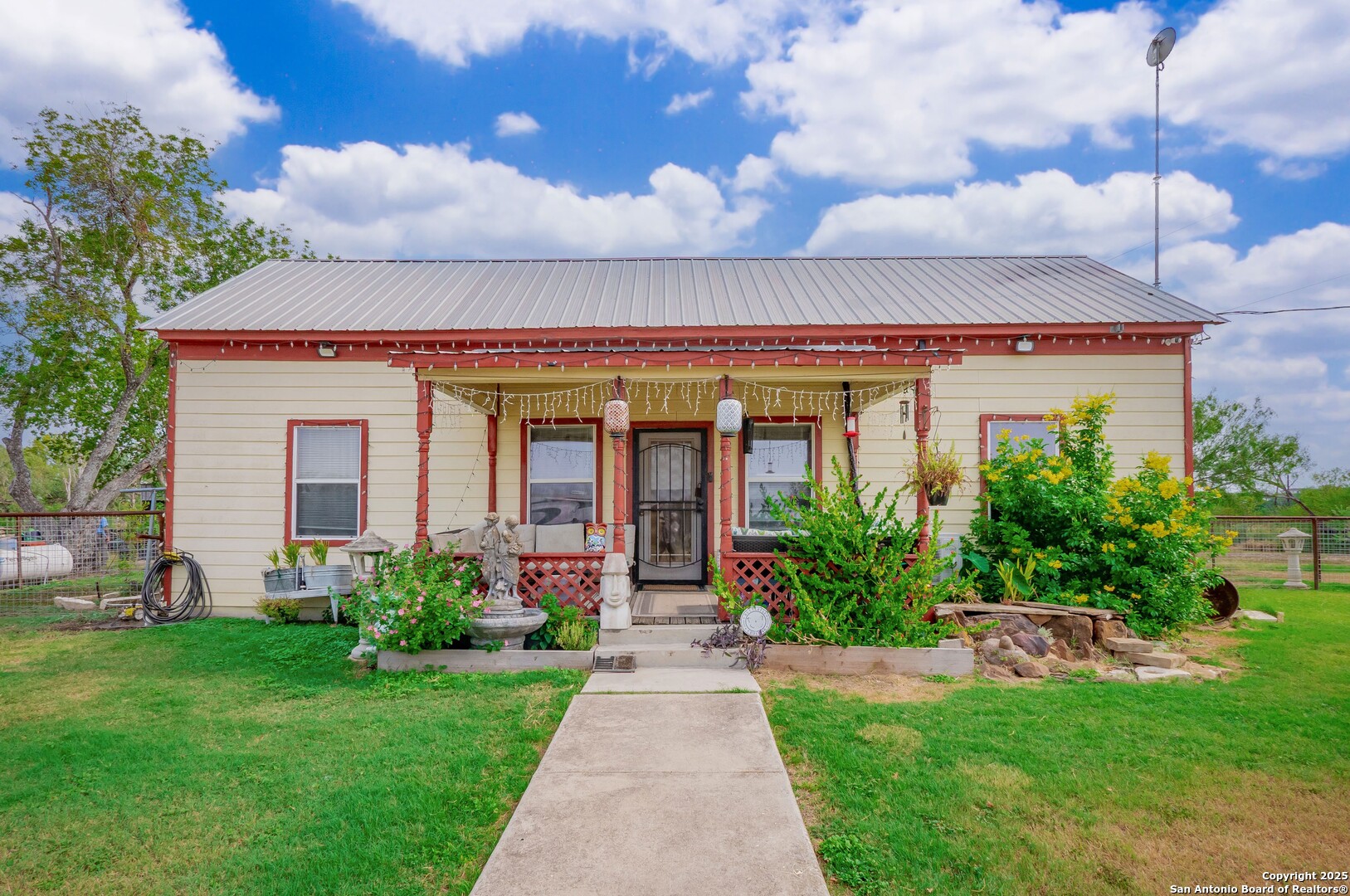 6147 Pfeil Road Schertz, TX 78154 - Photo 5 of 47 a view of a house with brick walls and a yard with plants