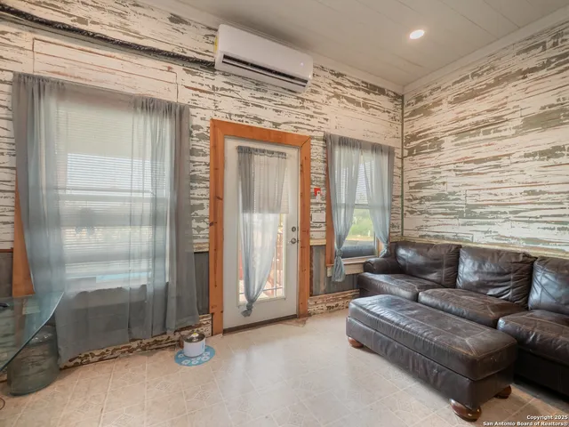 a living room with furniture and a ceiling fan
