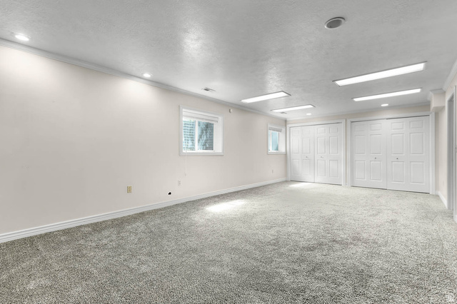 1822 East 9800th Street South Sandy, UT 84092 - Photo 18 of 38 Carpeted empty room featuring a textured ceiling and recessed lighting