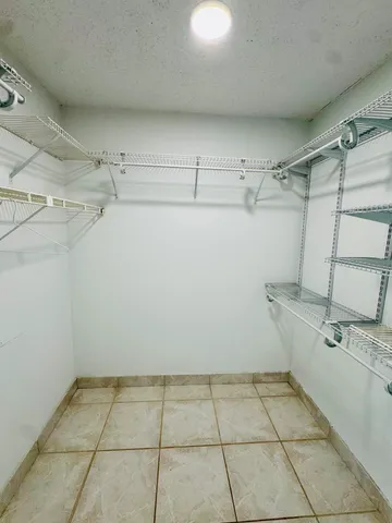 a kitchen with a granite countertop sink and cabinets