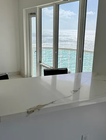 a bathroom with a bathtub and next to a window