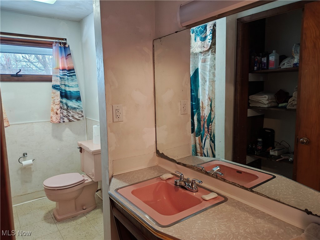 Bathroom with vanity and light floors