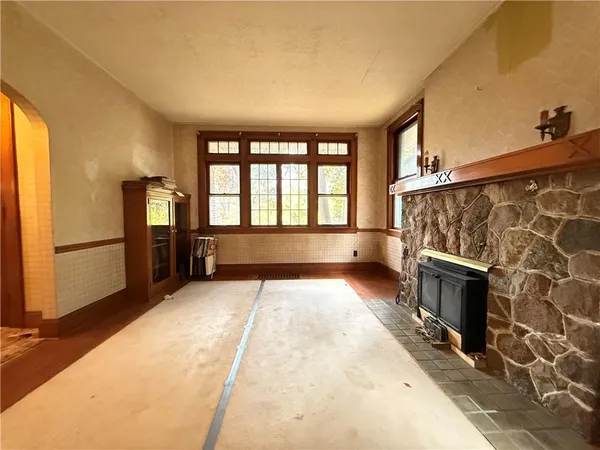 a living room with a rug and a fireplace