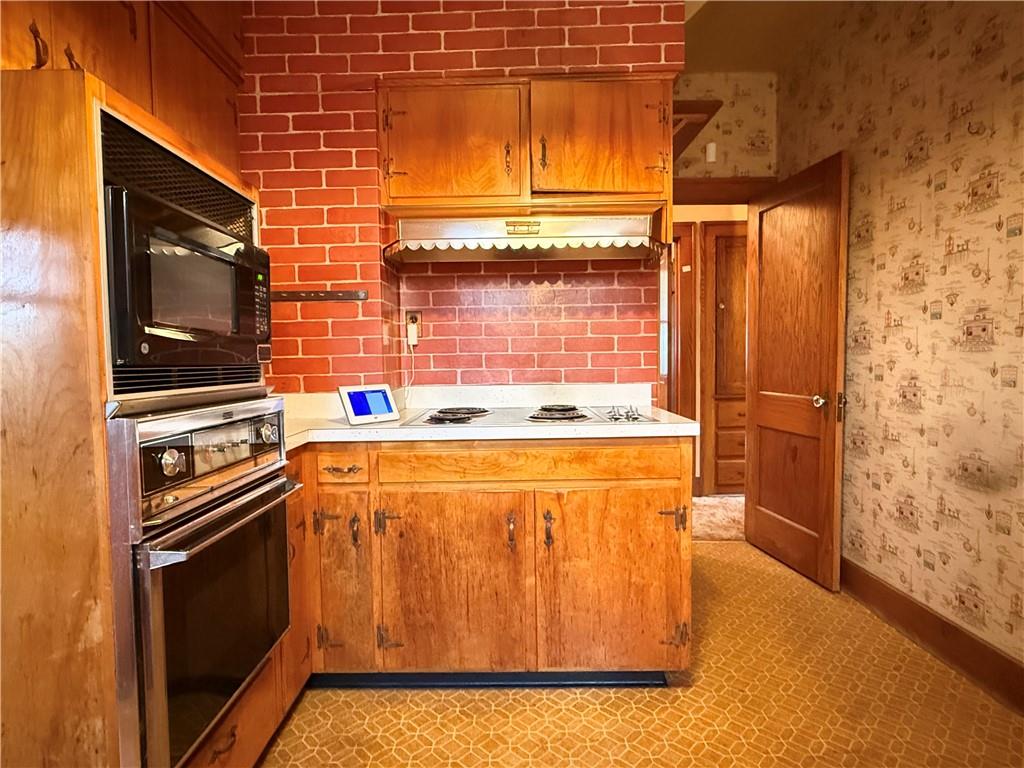 729 East Lake Road Transfer, PA 16154 - Photo 32 of 50 a kitchen with wooden cabinets and a stove top oven