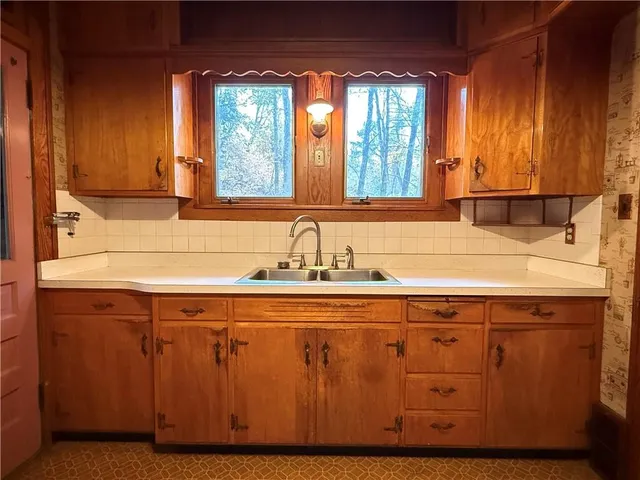 a kitchen with stainless steel appliances a stove a sink and a microwave