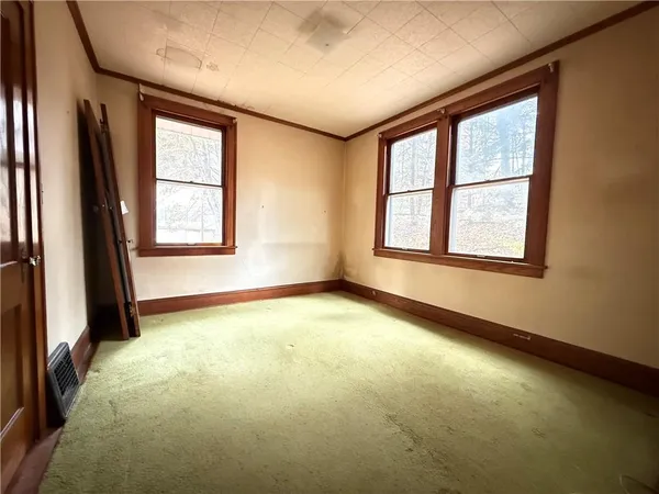 a view of an empty room with a fireplace
