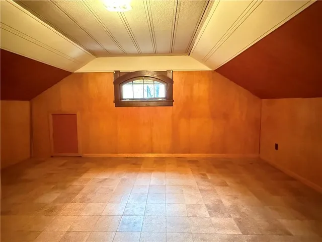 a view of empty room with wooden ceiling