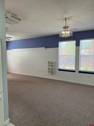 a view of a livingroom with furniture and chandelier